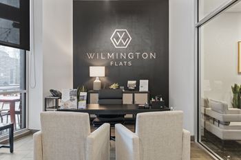 Wilmington flats show room with two chairs and a table.